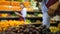 Male hand placing fresh grape in grocery store