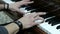 Male hand playing the piano. The guy plays the piano. Hands of a young man press the white and black keys of a musical