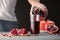 Male hand pouring pomegranate juice into a glass.