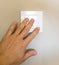 Male hand presses the switch and turns on the light