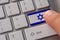 Male hand pressing keyboard button with flag of Israel on it. Online international business concept