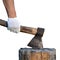 Male hand in a protective glove holds an old axe which is stuck in a stump isolated on white