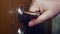 A male hand pulls a doorknob