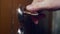 A male hand pulls a doorknob