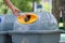 Male hand put used bottle in recycle bin