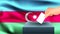 Male hand puts down a white sheet of paper with a mark as a symbol of a ballot paper against the background of the Azerbaijan flag