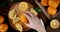 Male hand puts a juicy orange on a cutting Board.