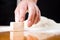 Male hand reaching yeast cube on baking table