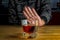Male hand rejecting glass with alcoholic beverage on blurred background. Concept