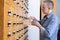 A male hand searching cards in old card catalogue. Man searching file