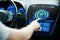 Male hand setting car eco system mode on screen