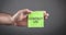 Male hand showing Contact Us message on sticky note