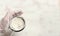 Male hand sifting flour from sieve on white kitchen table