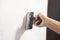 Male hand with a spatula putty wall. . Align the wall. White wall. Putty on the wall