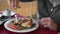 Male hand squeezes lime juice on smoked chicken