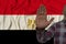 Male hand in stop gesture against the background of the beautiful silk national flag of Egypt, concept of caution, danger, vows,