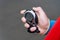 Male hand with a stopwatch on a gray background. Sports coach controls the timer