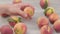 Male hand takes a peach fruit on wooden background