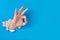 Male hand tearing through blue paper background creating ok gesture