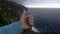 Male hand thumbs up against rocks and sea background, active recreation, tourism