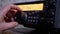 Male Hand Tunes Radio Communication Transceiver at Stationary Radio Station