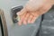 Male hand unlocking old used car door