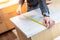 Male hand using tape measure on kitchen counter