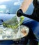 Male hand washes the car\'s hood from a watering can