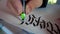 Male hand writes with ink pen letters of the Latin alphabet