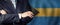 Male hands against Bahamian flag background, business, politics and education in Bahamas concept