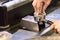 Male hands of a barista tamping coffee in a portafilter