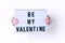 Male hands with Be My Valentine sign on white background.