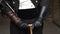 Male hands in black leather gloves hold a kind of cane. Steampunk costume. Art space