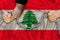 Male hands break the iron chain, a symbol of bondage,protest against the background of national flag Lebanon, concept of political
