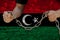 Male hands break the iron chain, symbol of tyranny, protest against the background of the national flag of Libya, the concept of