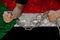 Male hands breaking the iron chain, symbol of bondage, protest against the background of the national flag of Sudan, the concept