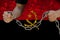 Male hands breaking the iron chain, symbol of bondage, protest against the background of the state flag of Angola, the concept of