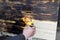 Male hands burning wooden desk, table, surface with burner, woodburning handcraft outside. Close up man holding gas