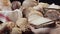 Male hands butter a piece of fresh baked Dutch bread above the wooden table