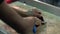 Male hands cleaning silver fish with a knife.