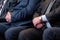 Male hands closeup. Abstract middle-aged men in a suit of an official or a businessman at a meeting. Wristwatches, shirt, tie.