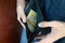 A male hands with coins with small Ukrainian bills and black old purse