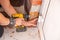 Male hands of  construction worker tighten and fix  screws and self-tapping screw  with  electric cordless screwdriver for home