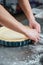 Male hands cooking pie in baking pan