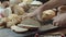 Male hands cutting the fresh baked Dutch bread on the wooden table