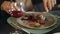 Male hands cutting meat steak at restaurant. Business man dining in restaurant