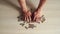 Male hands are drawn to the pile of coins on the table. The theme of financial crisis and poverty