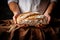 Male hands with fresh baked wheat bread. Close up