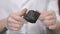 Male hands in gloves holding coal. Scientist with a sample of coal. Black coal in miner`s hand