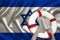 Male hands hold on a white lifebuoy against the background of the silk national flag of the country of Israel, the concept of